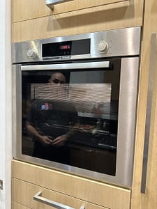Tecnico DanorAssistance esegue la riparazione e l'assistenza tecnica su un forno da incasso Fulgor Milano di alta gamma.